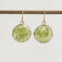 Green stone earrings on a white background