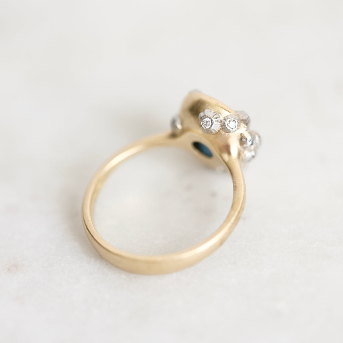 Gold ring with platinum barnacle accents set with diamonds. Photographed from the back. 