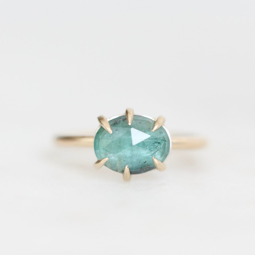 Green tourmaline ring with inclusions held in prongs