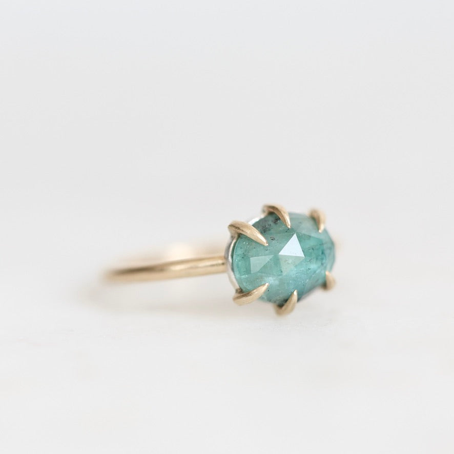 Green stone ring held in prongs 
