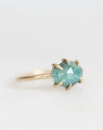 Green stone ring held in prongs 