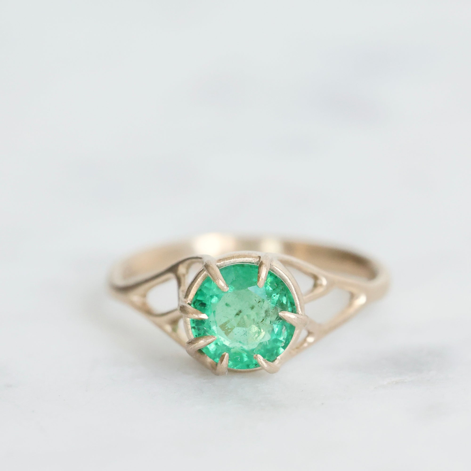 Green gemstone ring in gold branchy prongs