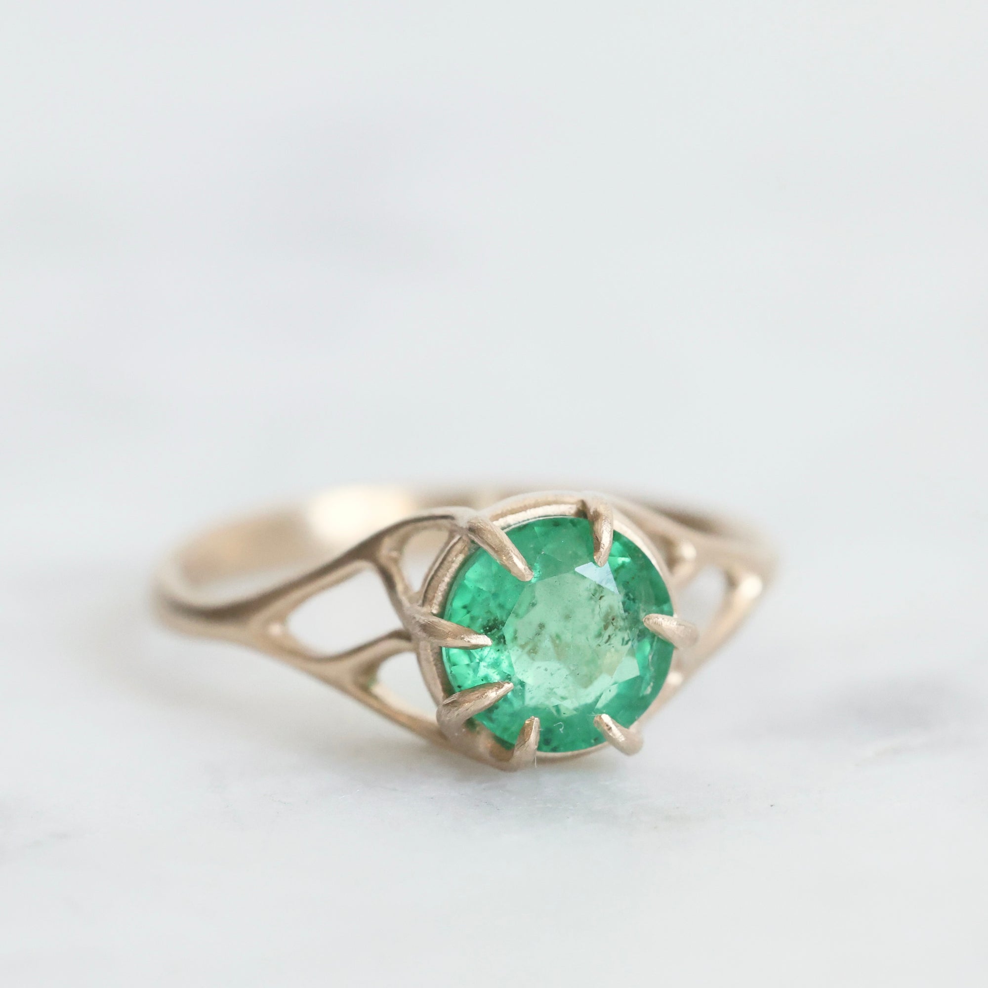 Green gemstone ring in gold branchy prongs