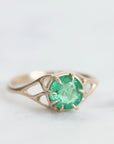 Green gemstone ring in gold branchy prongs