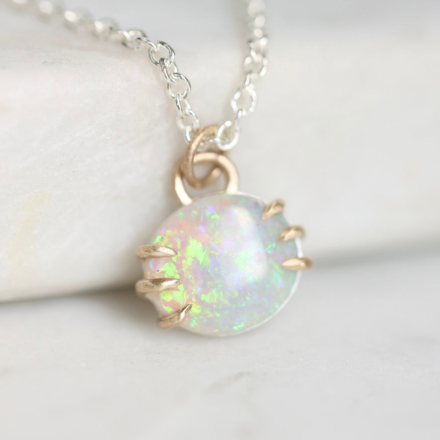 Opal pendant with gold prongs
