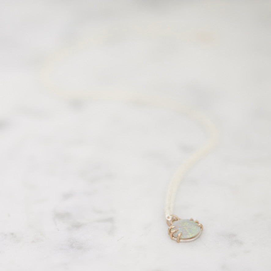 Opal necklace laid out on marble 