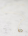 Opal necklace laid out on marble 