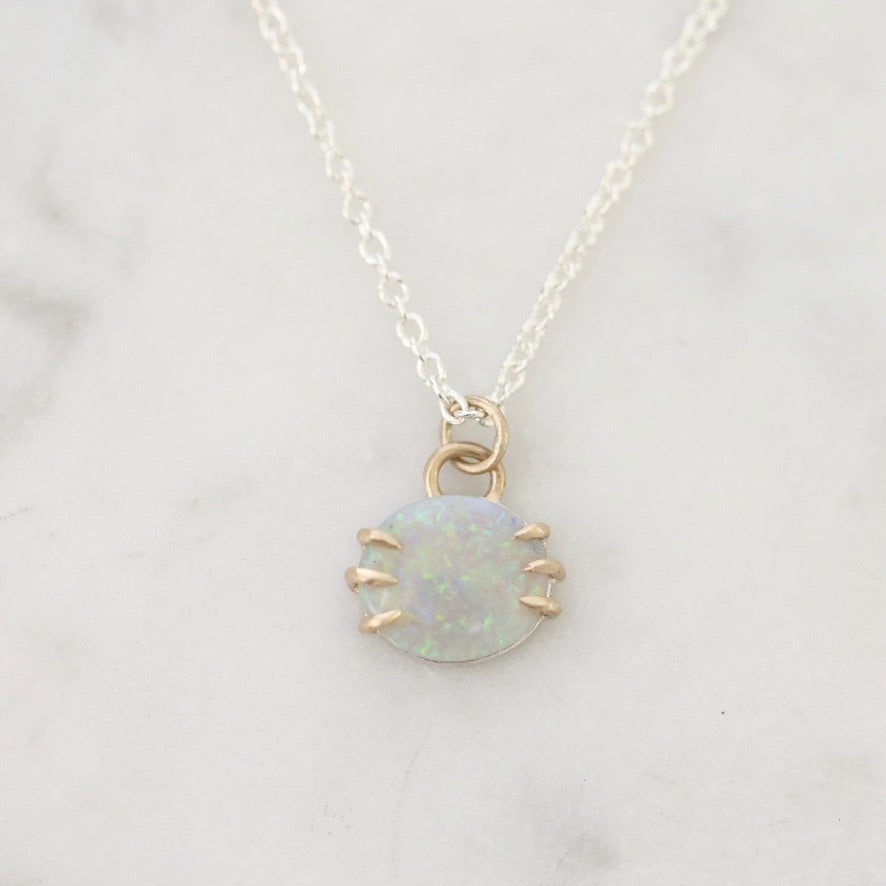 Opal pendant on marble background