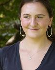 Woman wearing opal pendant 