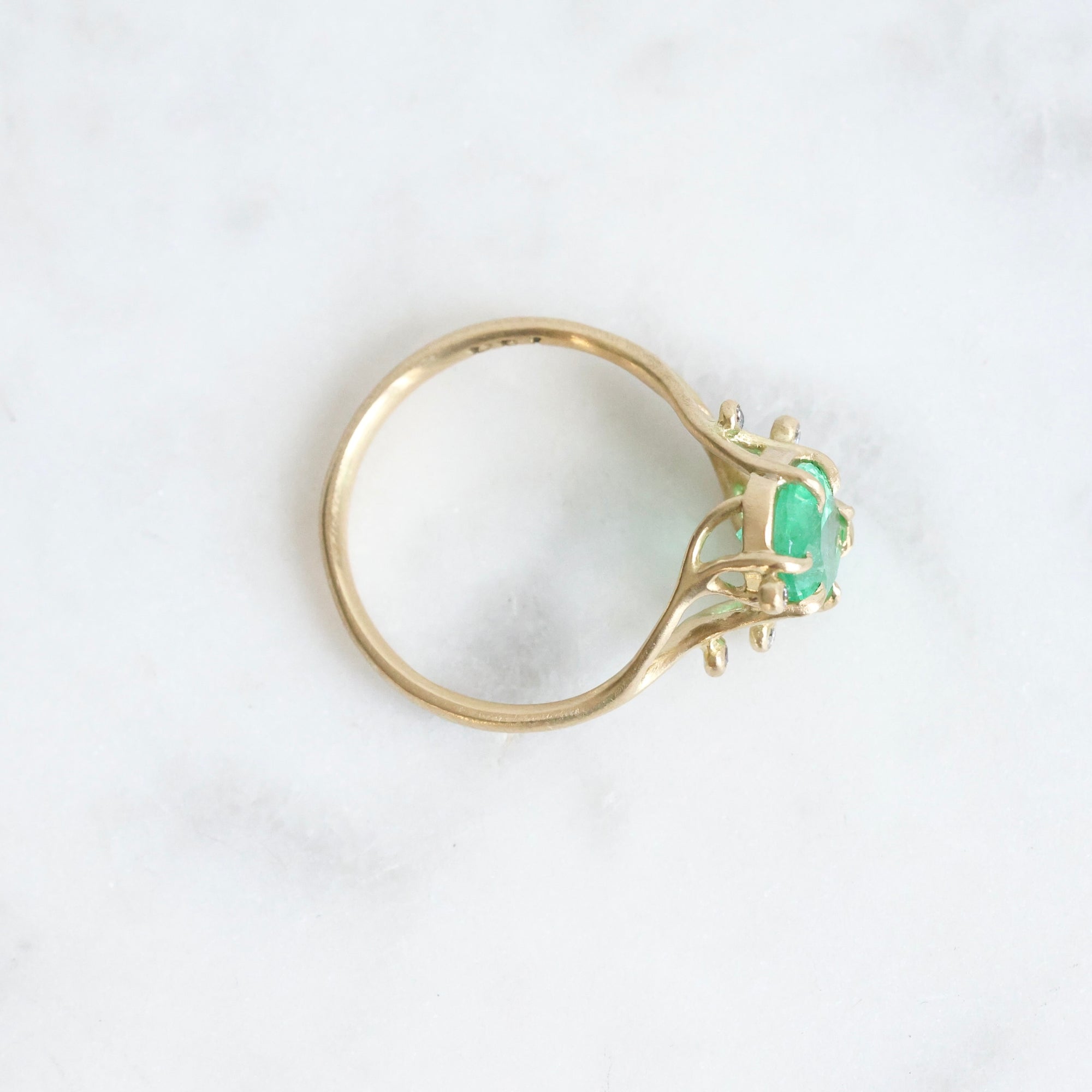 Bright green stone ring with diamonds and branchy prongs