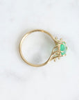 Bright green stone ring with diamonds and branchy prongs