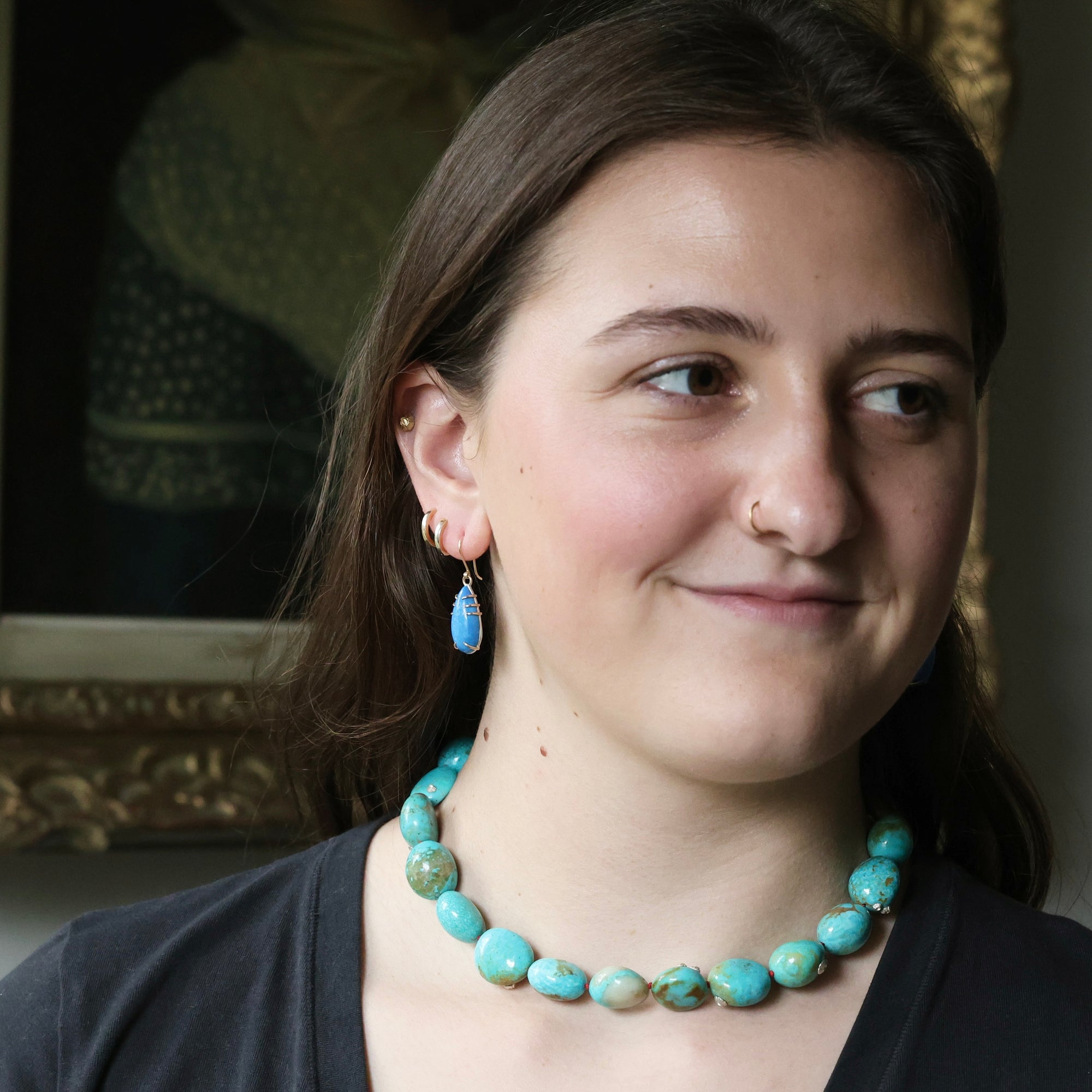 Woman wearing blue earrings and chunky strand