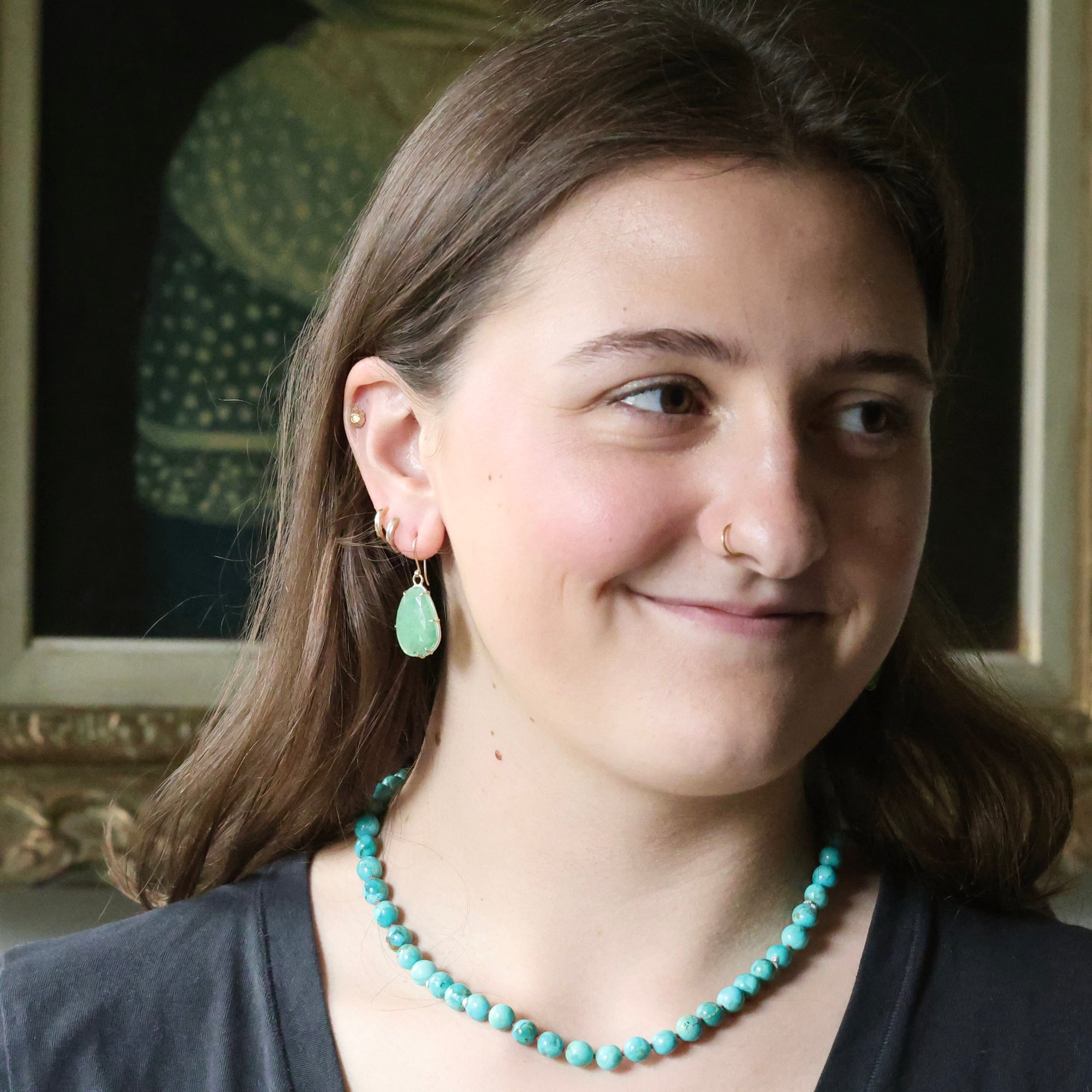 Woman wearing green earrings