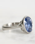 Silver ring with a blue gemstone on a white background