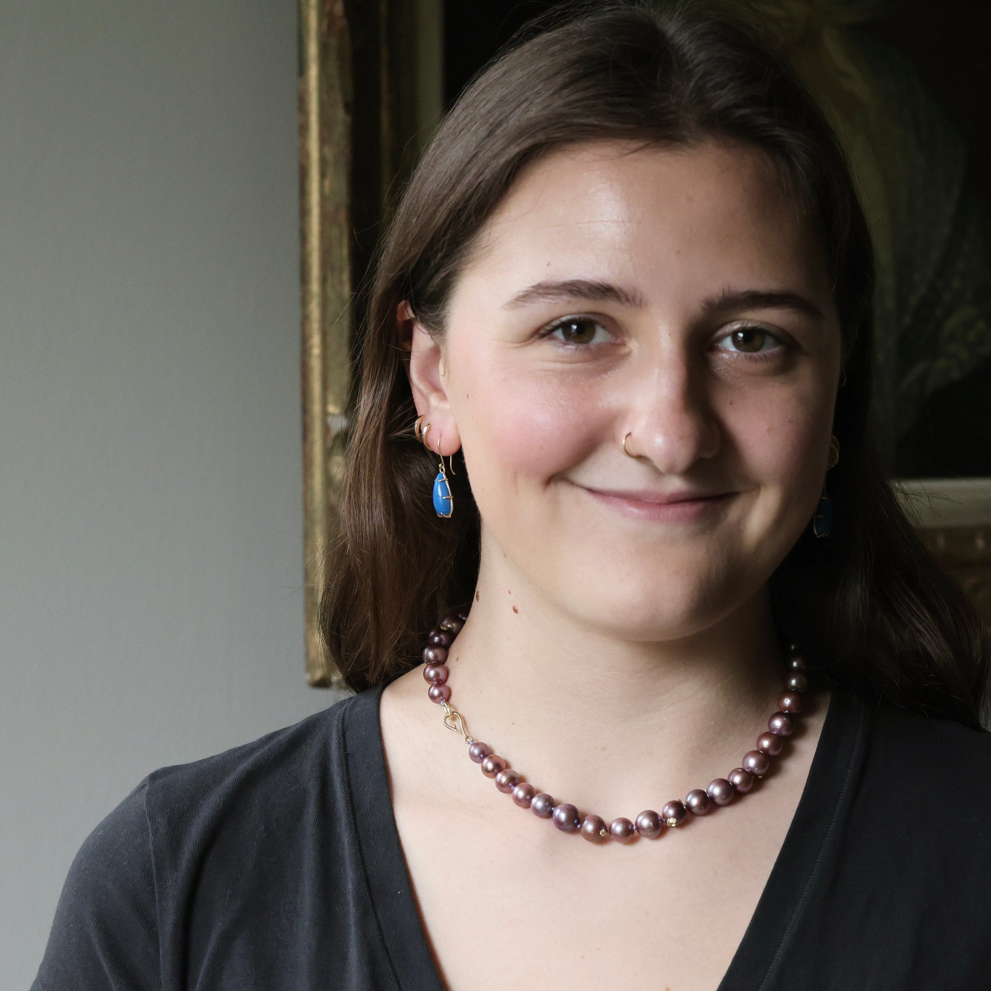 woman wearing strand of pink pearls