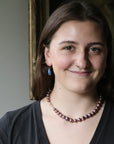 woman wearing strand of pink pearls