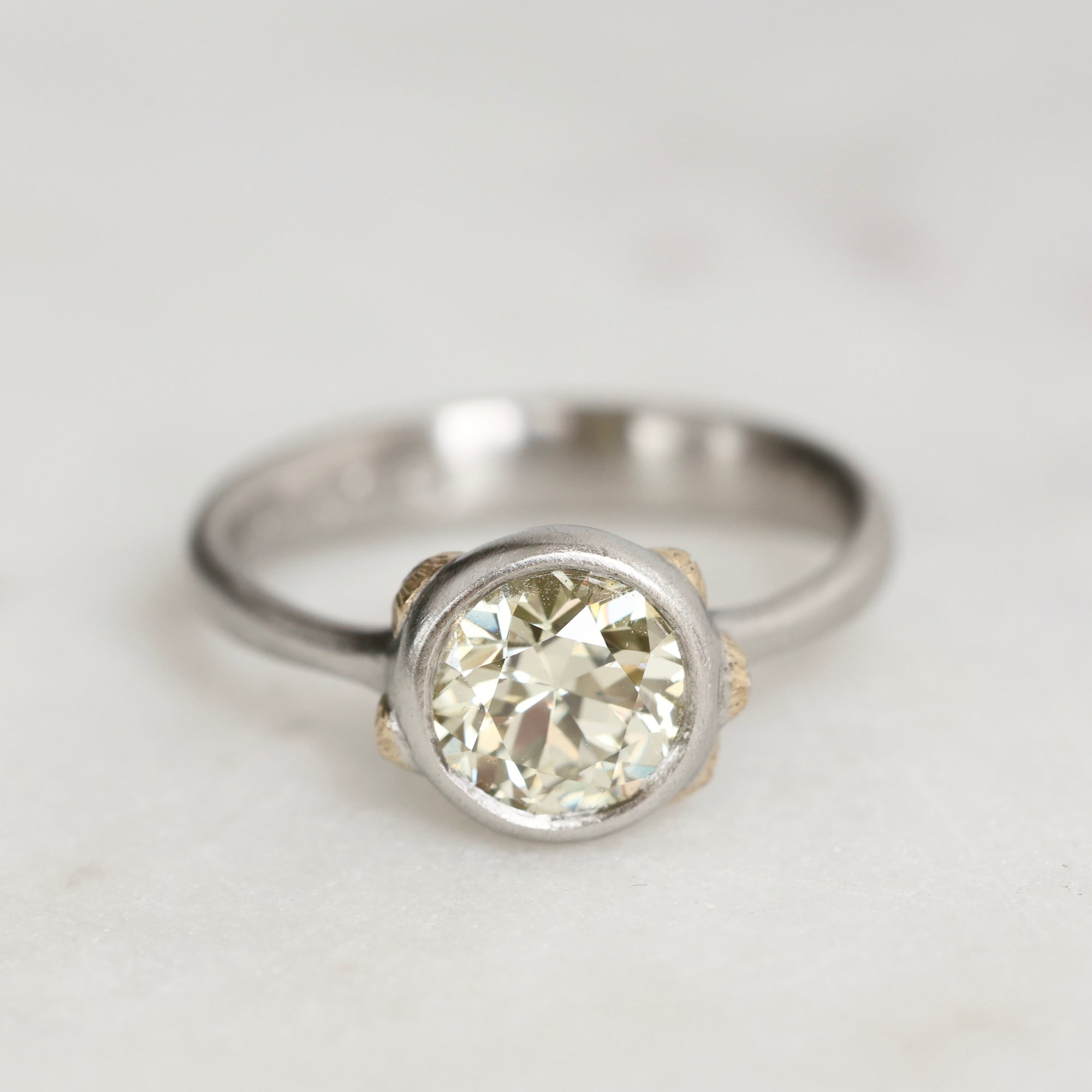 Platinum Ring with Gold Barnacles and a yellow diamond on a white background