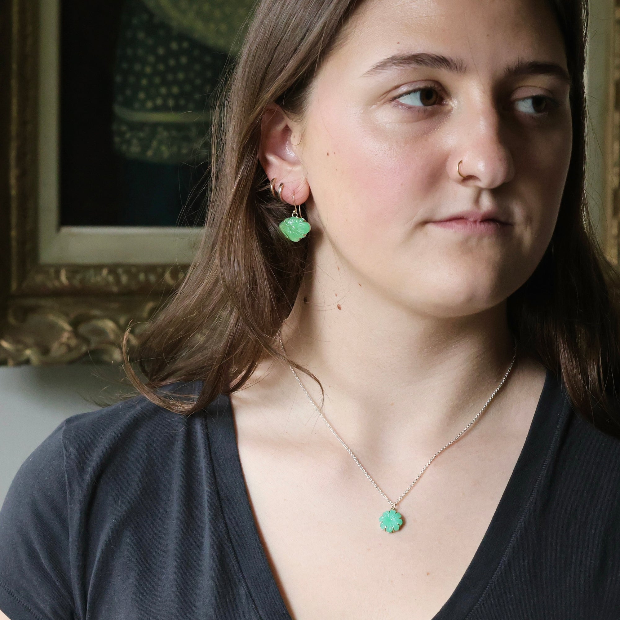 Woman wearing green pendant necklace