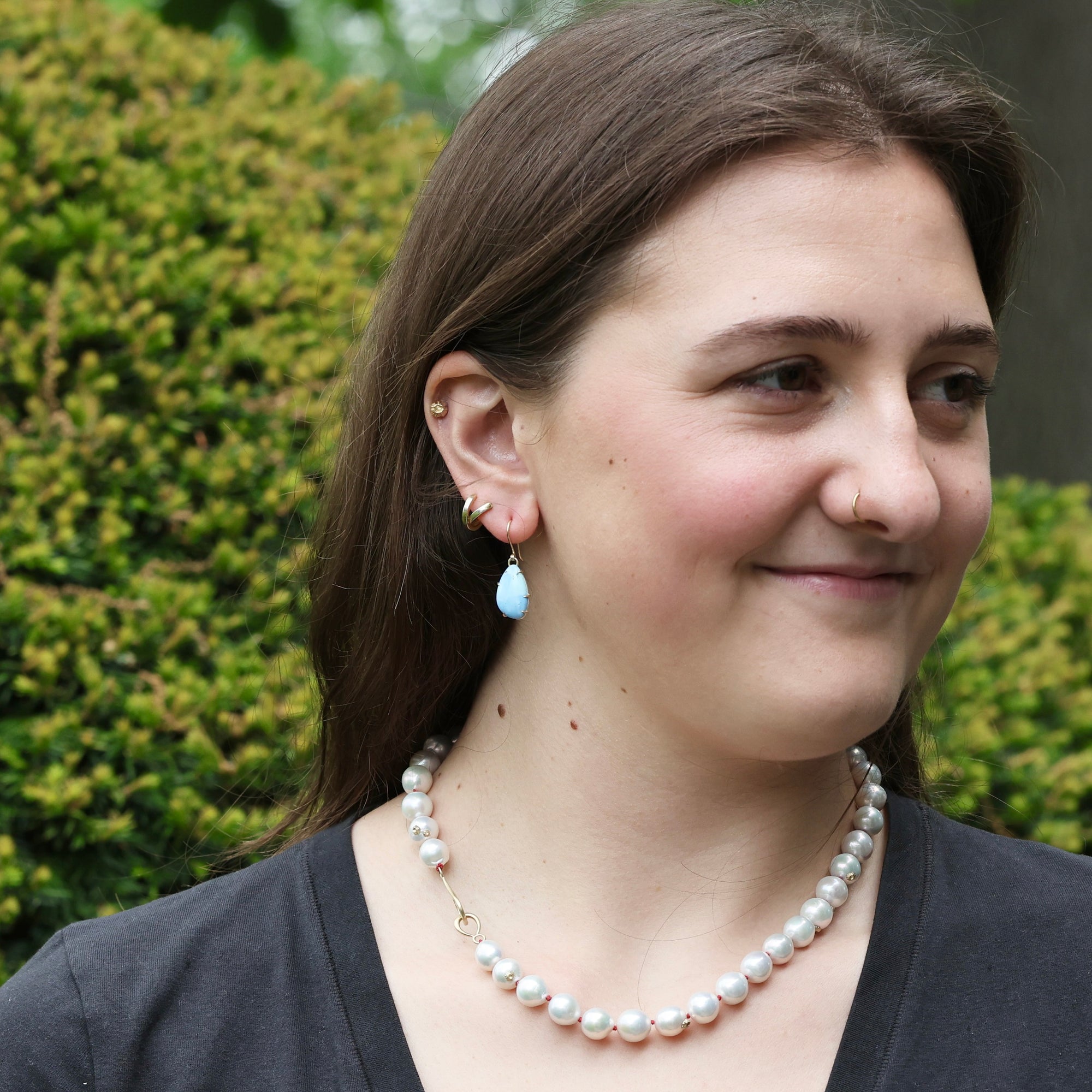 Woman wearing blue teardrop shaped earrings