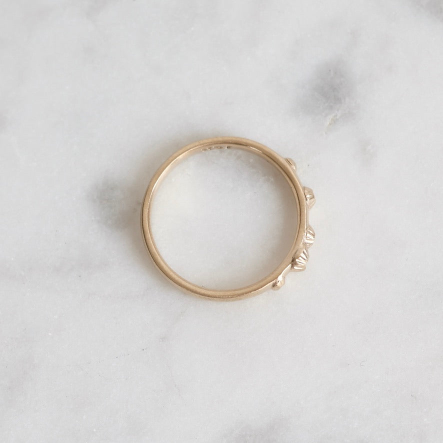 Gold ring on a light marble surface