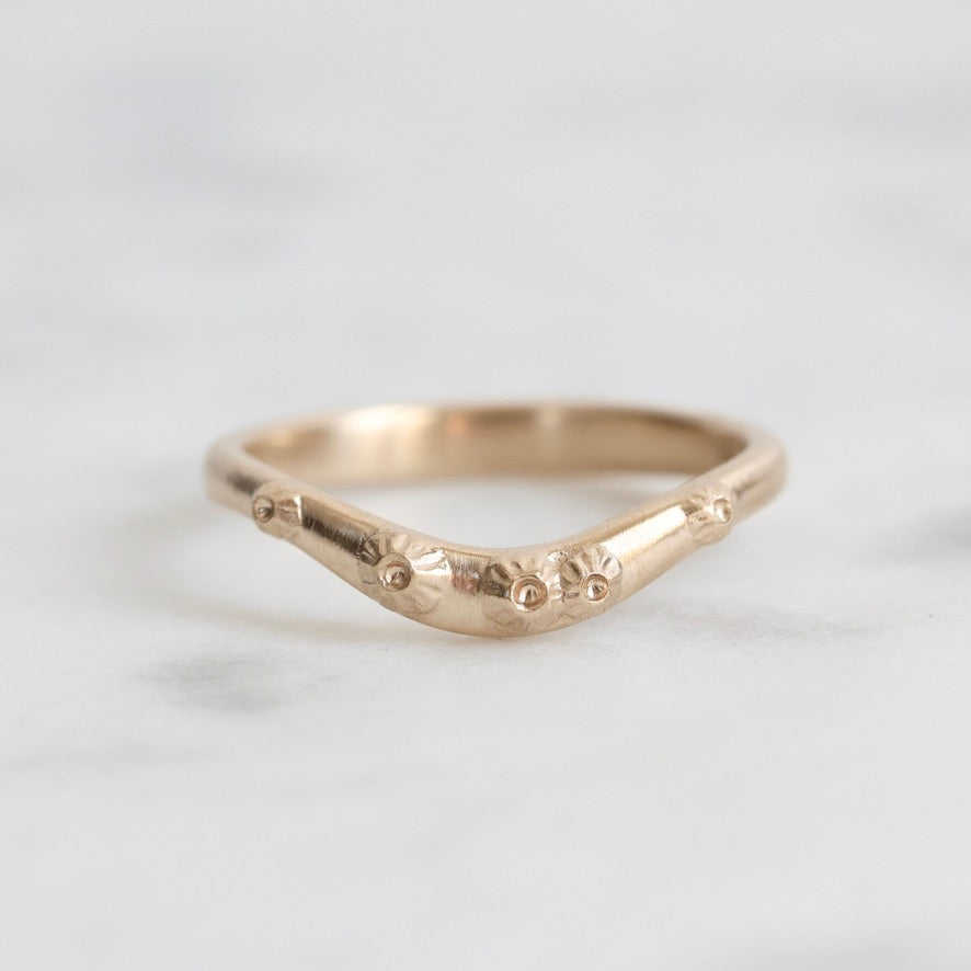 solid gold curved ring with barnacles