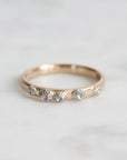 Gold ring with shell designs on a light gray background