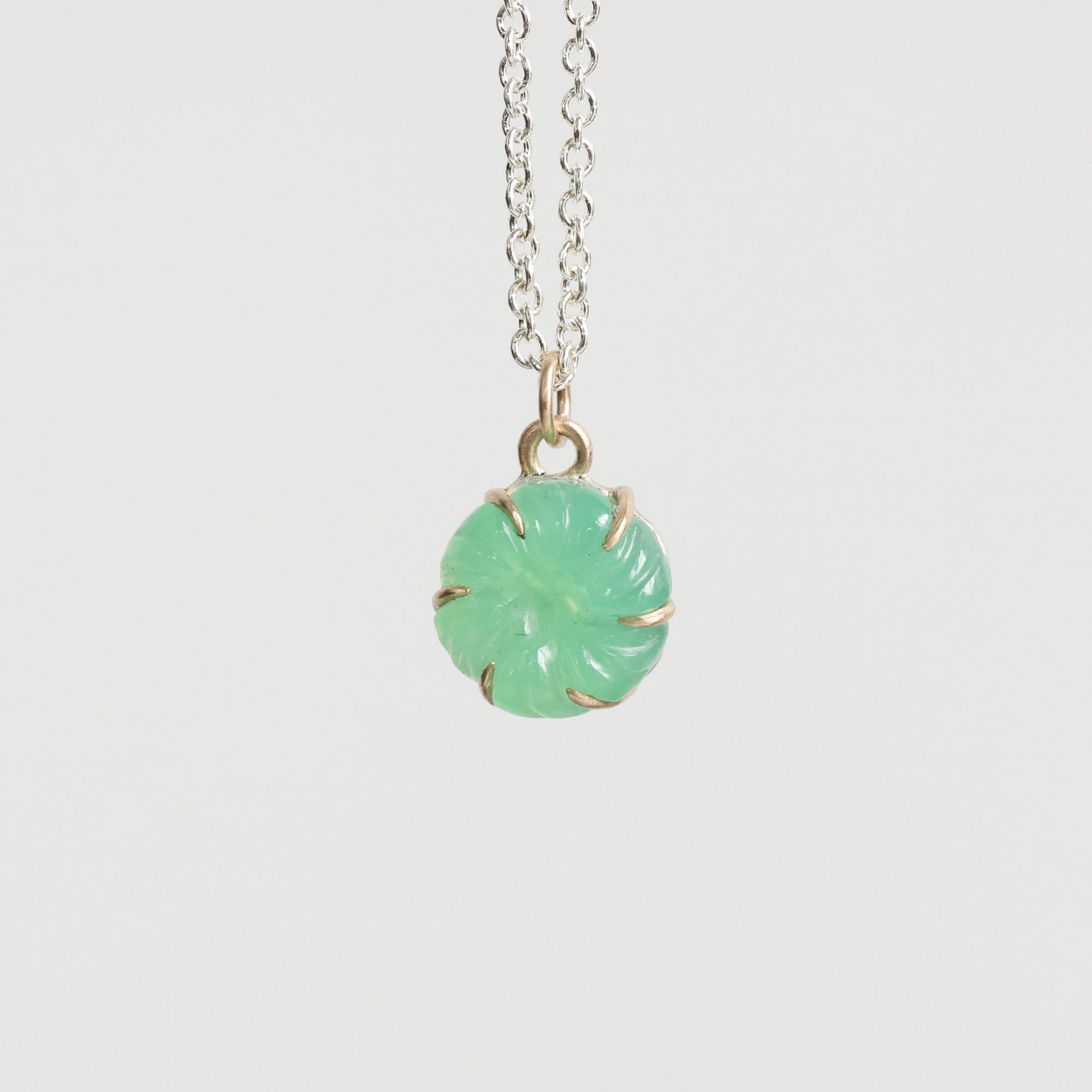 Necklace with a green pendant on a white background