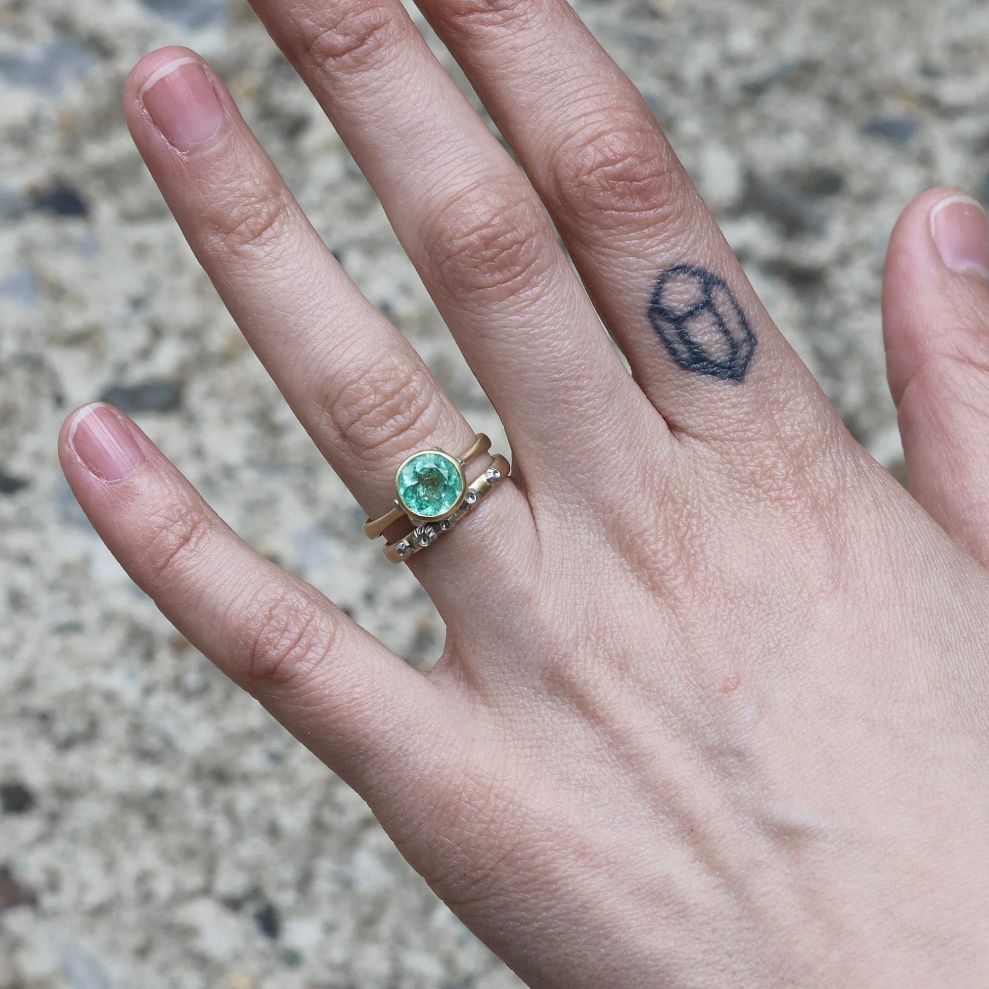 barnacle band stacked with green gemstone ring