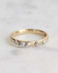 Gold ring with barnacles on a light gray background