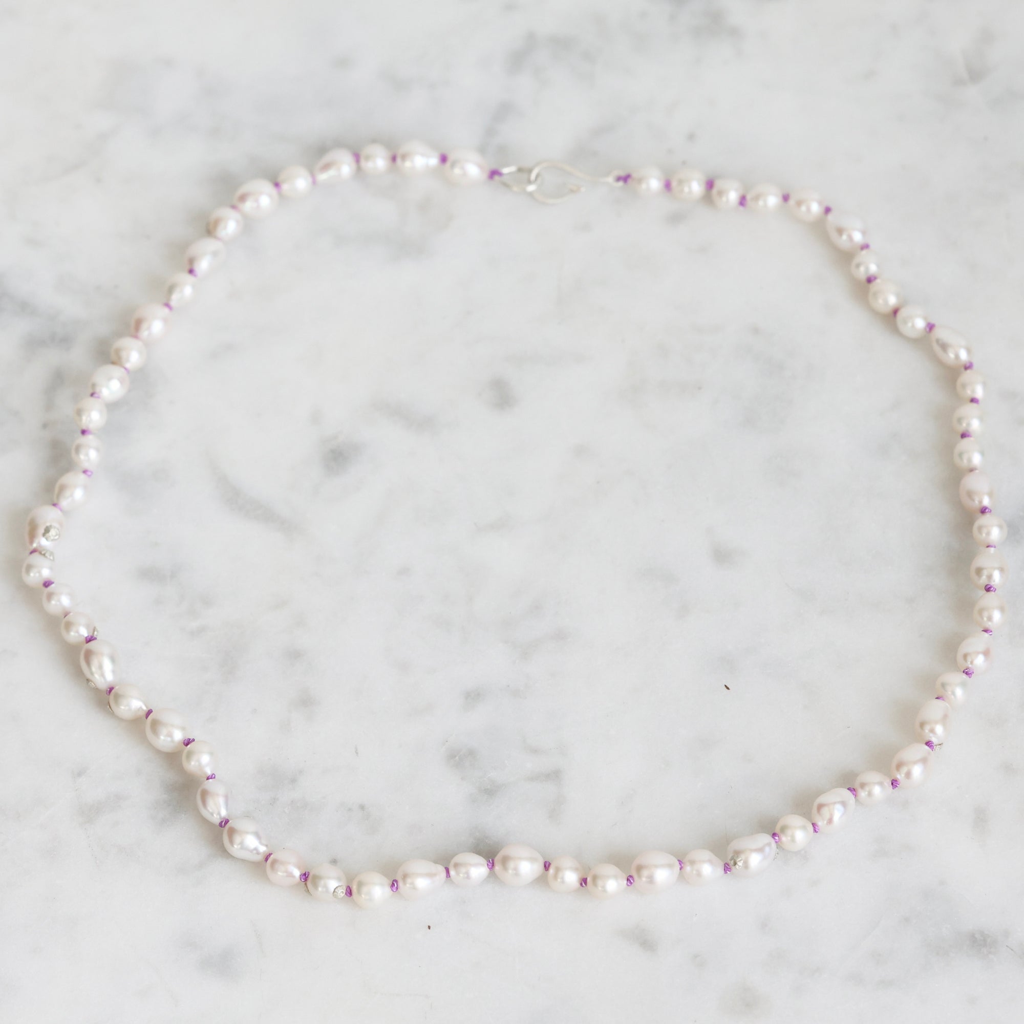 Pearl necklace on a marble surface