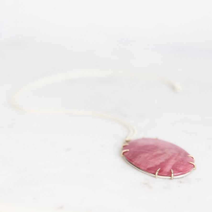 Large pink stone pendant set in gold prongs