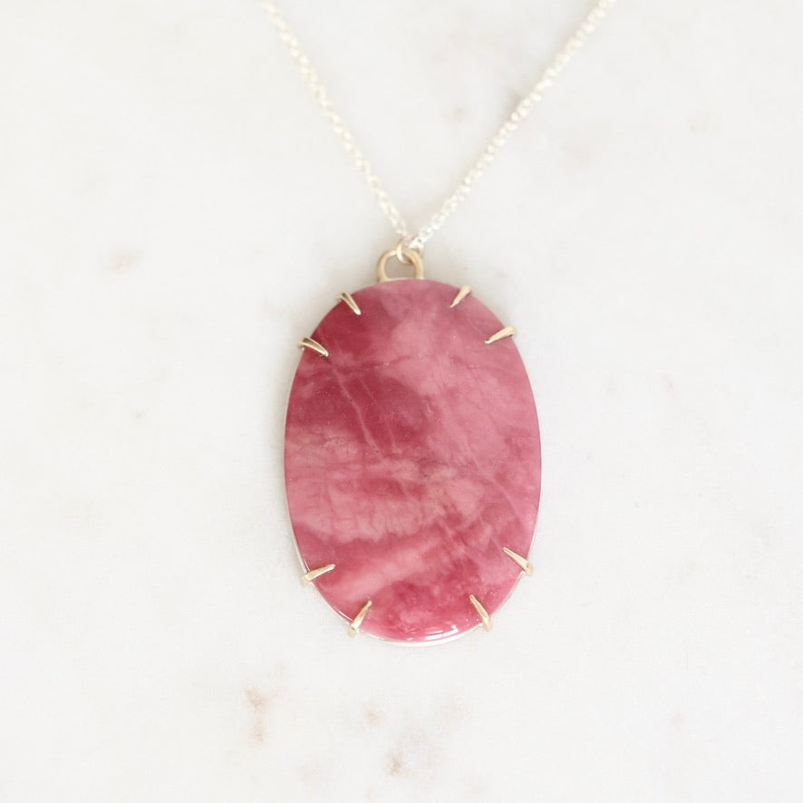 Large pink stone pendant in gold prongs