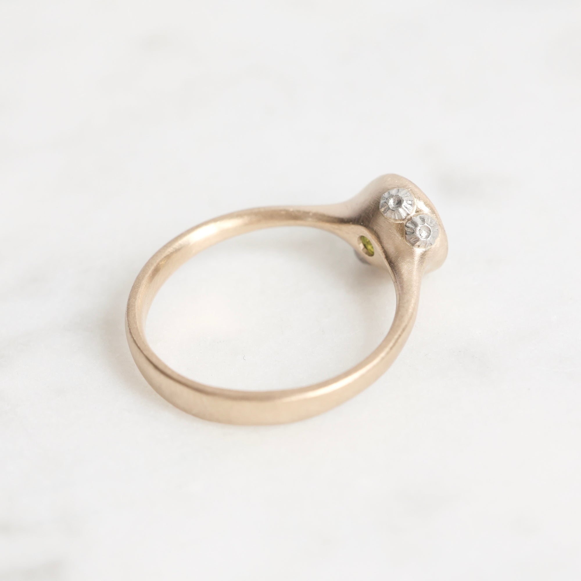 Gold ring with barnacle details on a white background