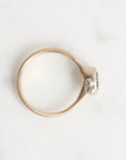 Gold ring with a diamond on a white background