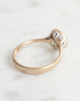 Gold ring with small diamonds on a white background
