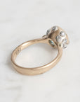 Gold ring with gemstones on a light gray background
