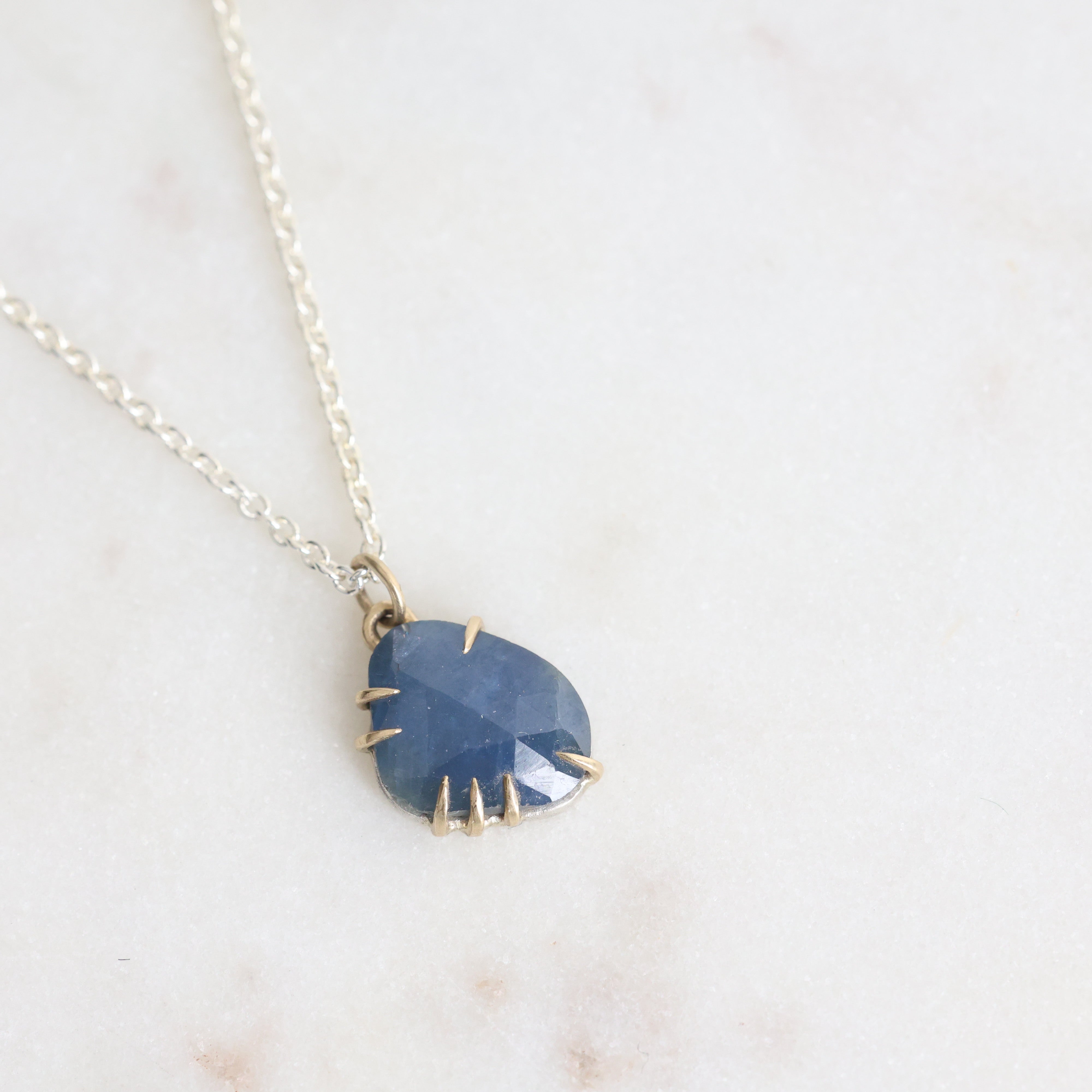 Necklace with a blue pendant on a light background