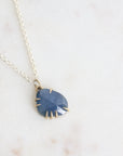 Necklace with a blue pendant on a light background