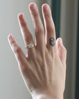 Hand with a diamond ring on a neutral background