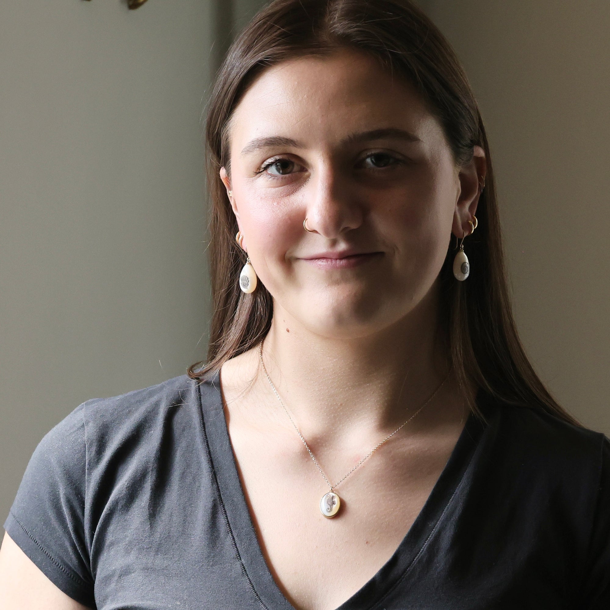 Woman wearing a gray shirt with a neutral background
