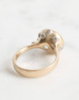 Gold ring with a large, faceted aquamarine stone on a light background