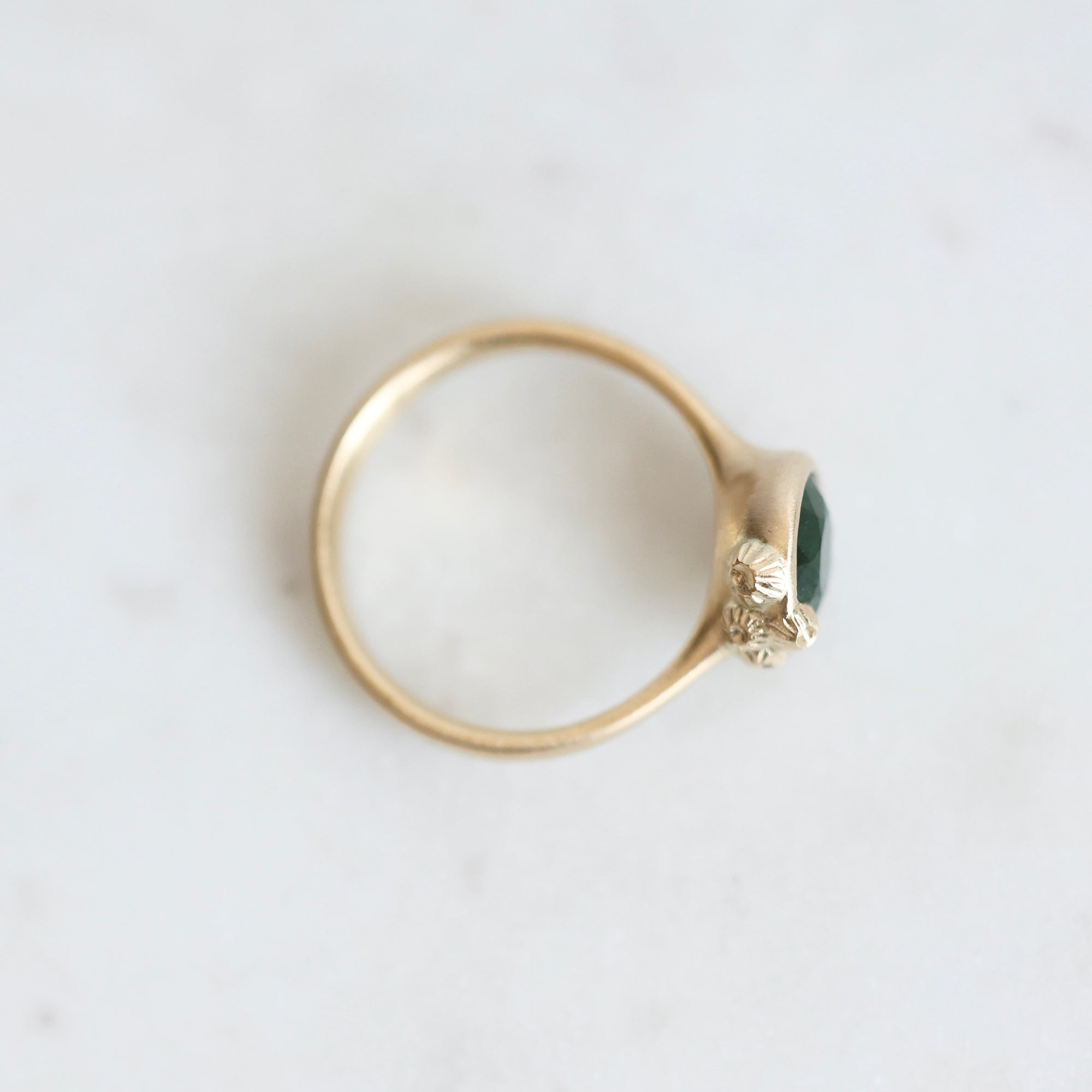 Top view of gold Ruthie B. Ring with gold clustered barnacles. Green main stone visible 