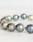 Pearl necklace with gold accents on a light background