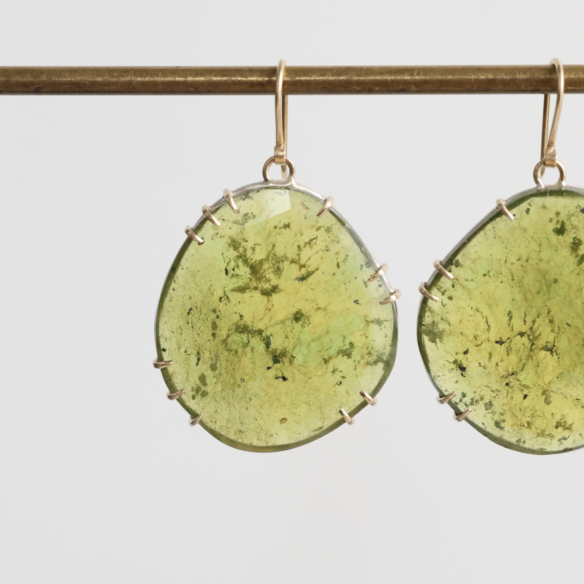 Green stone earrings on a white background