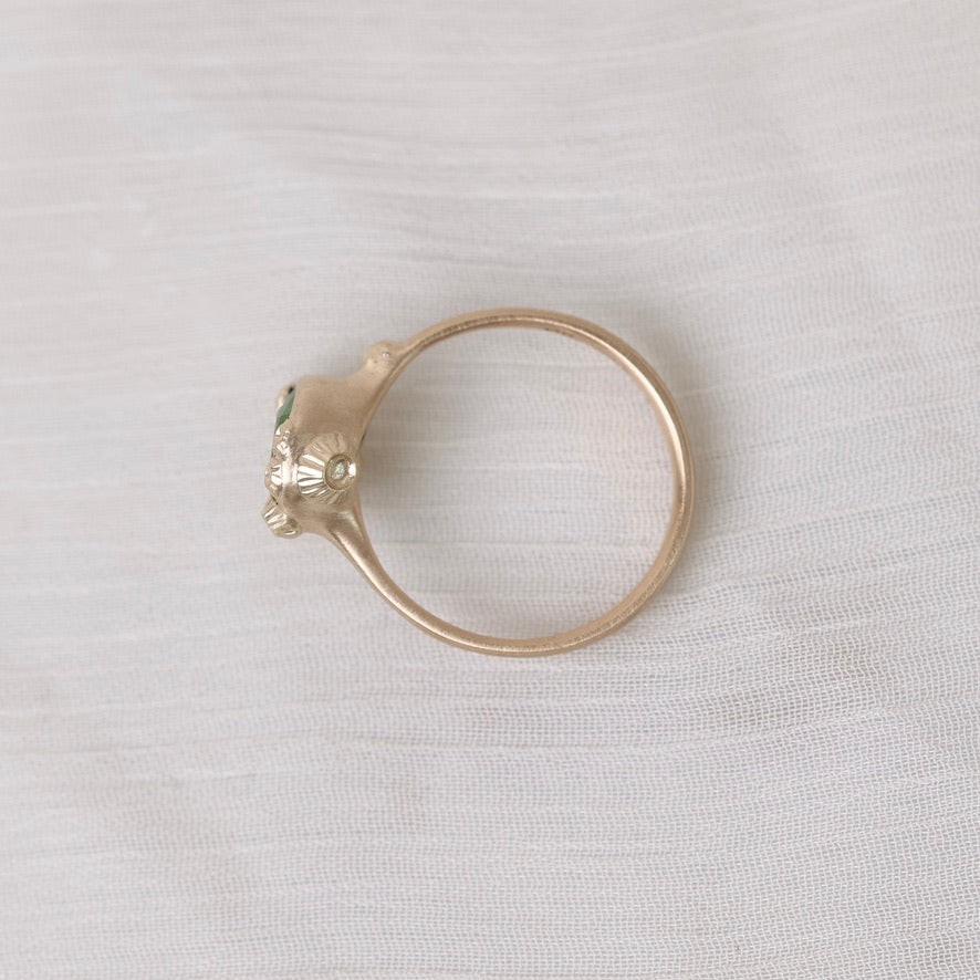 Gold ring with barnacle on gray background