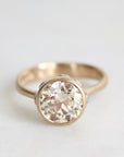 gold ring facing forward with a diamond and platinum barnacles against a white background