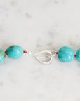 Turquoise Strand with silver barnacles and red thread