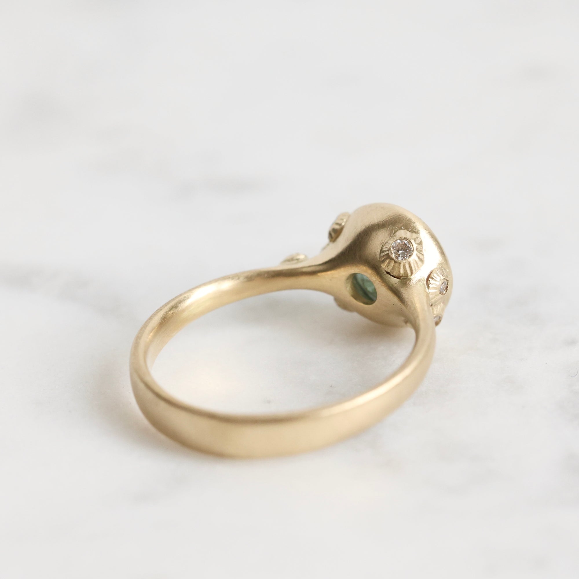 Gold ring with gemstones on a white background