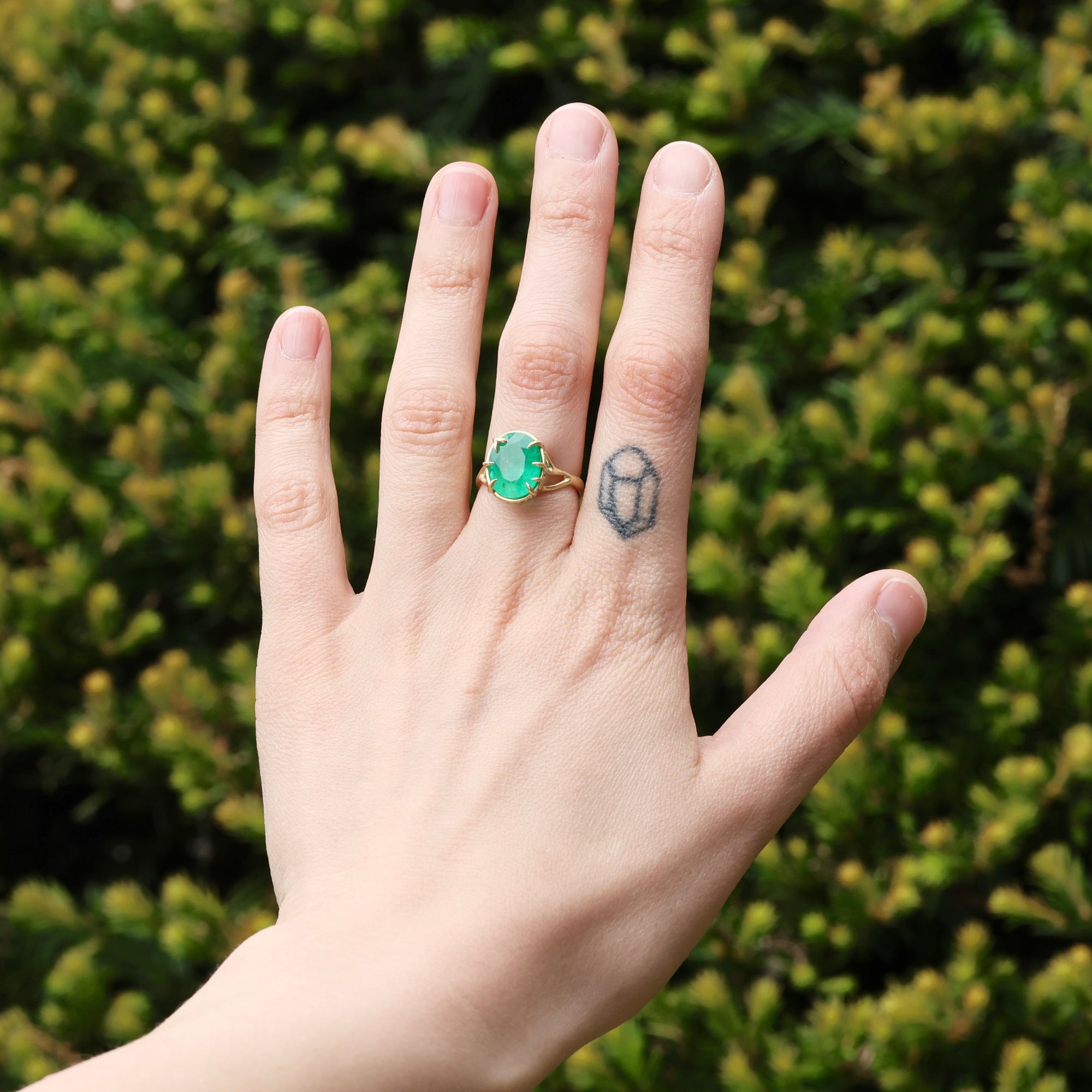 Large green gemstone ring on hand