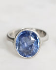 Silver ring with a blue gemstone on a white background